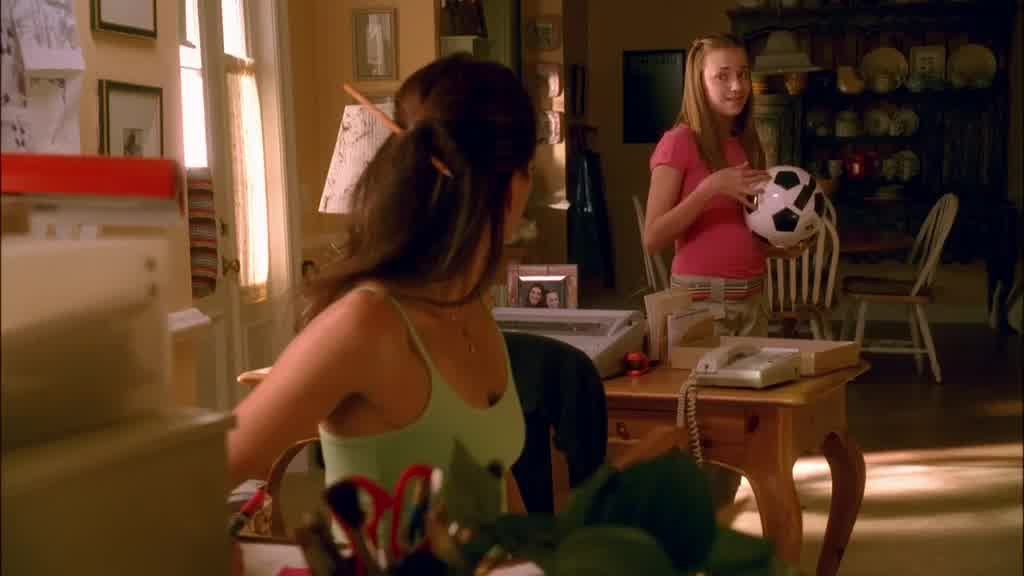 JULIE tilts her head to one side, smiling at Susan.jpg