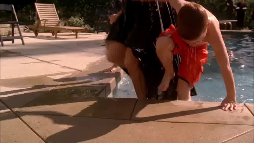 She manages to pull them up the steps and out of the pool, herself soaking wet.jpg