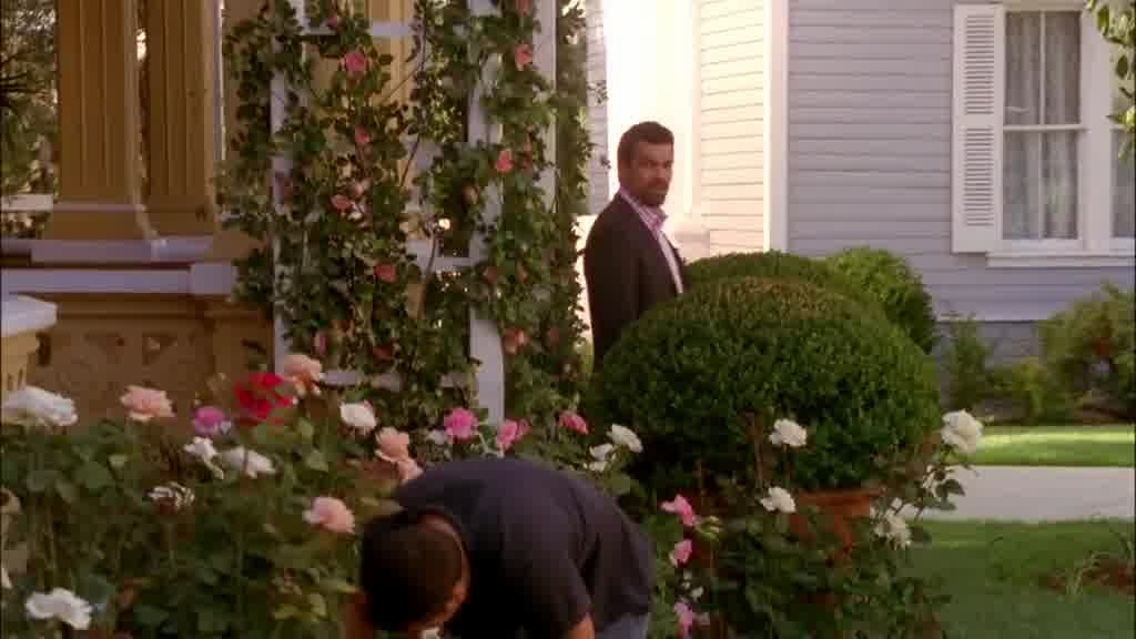 CARLOS walks out of the front door and down the porch steps.jpg