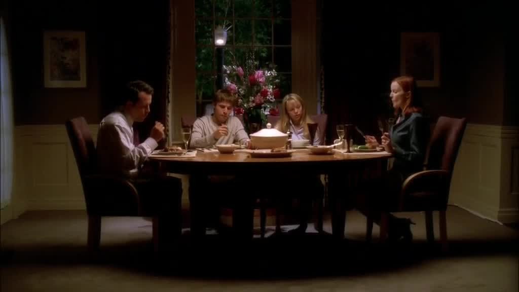 The VAN DE KAMP family is seated, eating silently.jpg