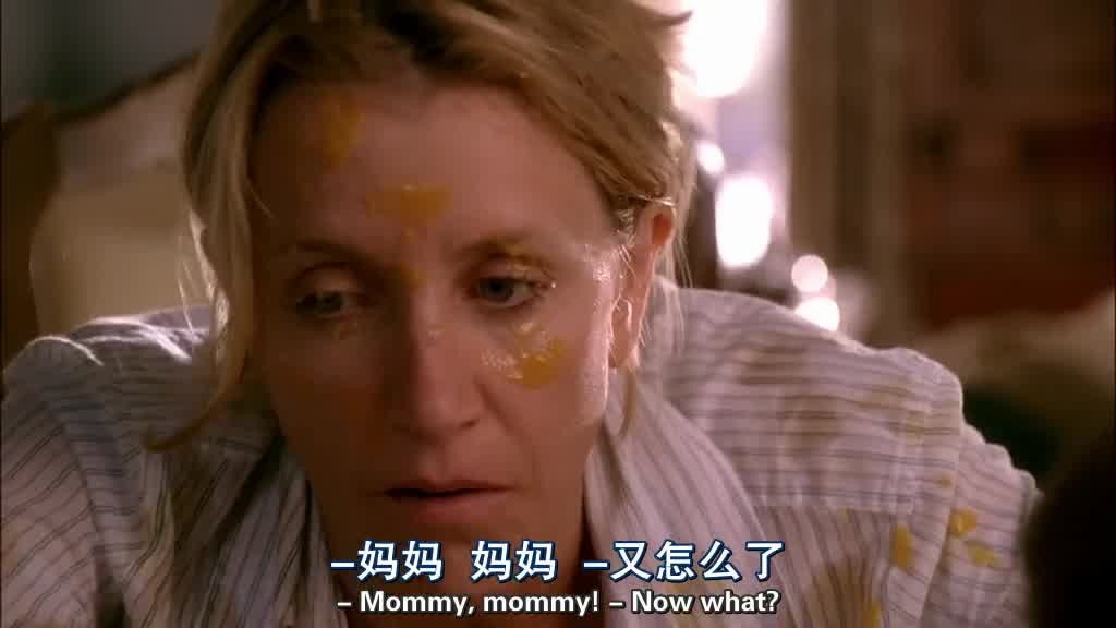 The baby flicks a spoonful of peaches onto LYNETTE's face and shirt.jpg