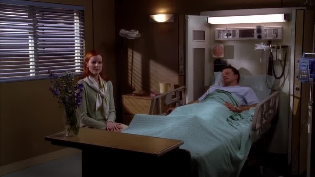 Bree sits a chair next to the bed, avoiding his eyes.jpg