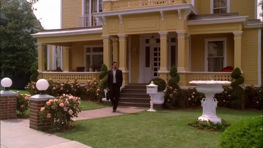 CARLOS comes out of the front door and walks down the walkway.jpg