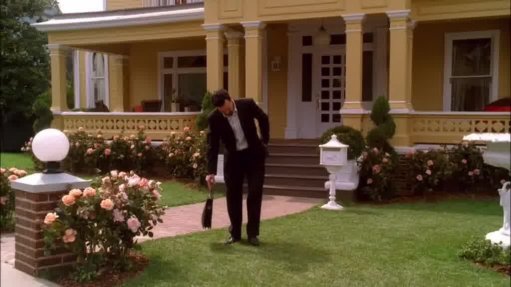 He stops and crouches down to run his hand along the mowed grass.jpg