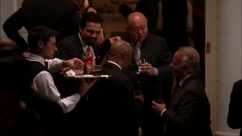 She sees CARLOS with TANAKA, a drink on his hand, who hasn't even noticed t.jpg