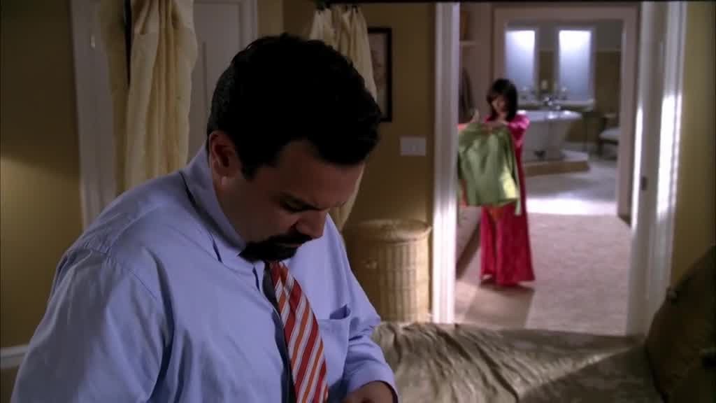 We see Gabrielle in the walk in closet trying to decide what to wear.jpg