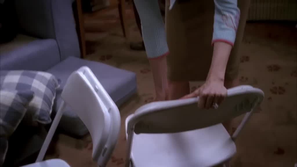 Bree is helping to pack up the folding chairs.jpg