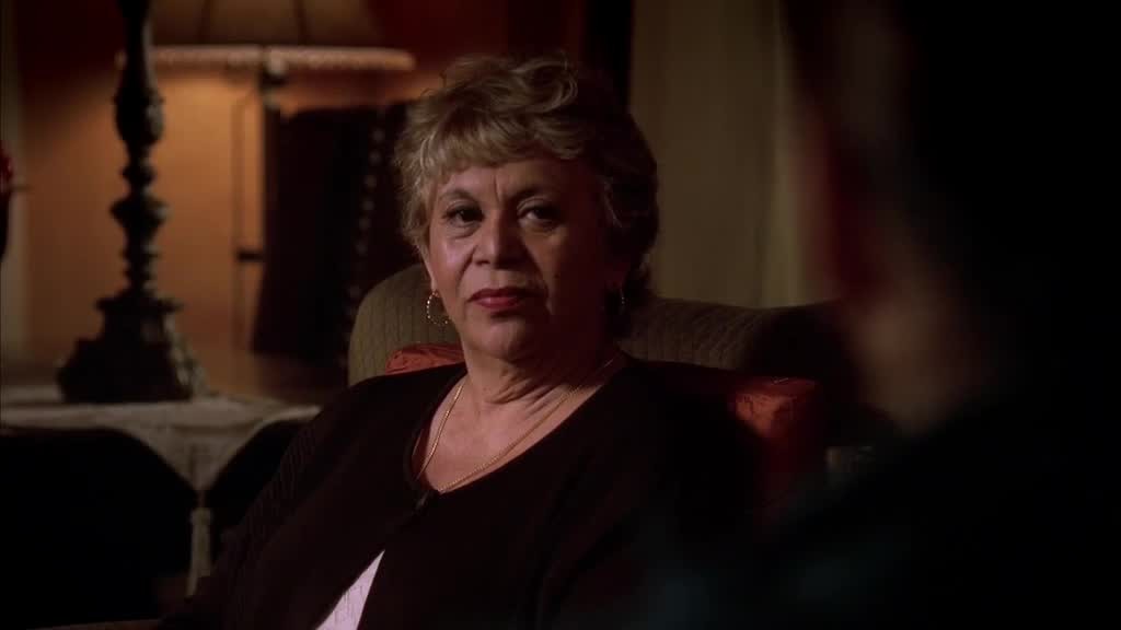 Mama Solis looks straight at her, with no nonsense.jpg