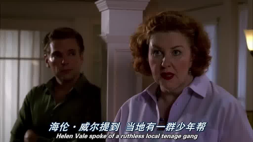 shot of a large, motherly looking woman talking to the gathered crowd.jpg