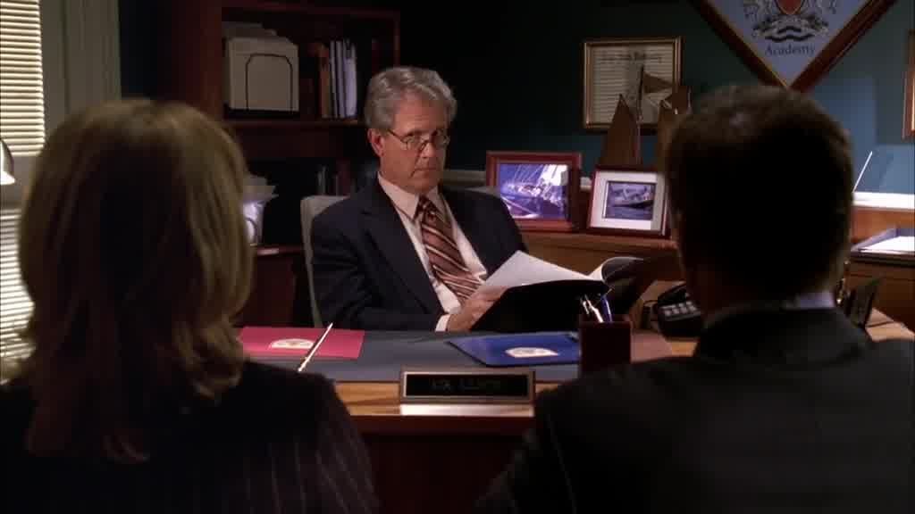The headmaster is looking through the file.jpg