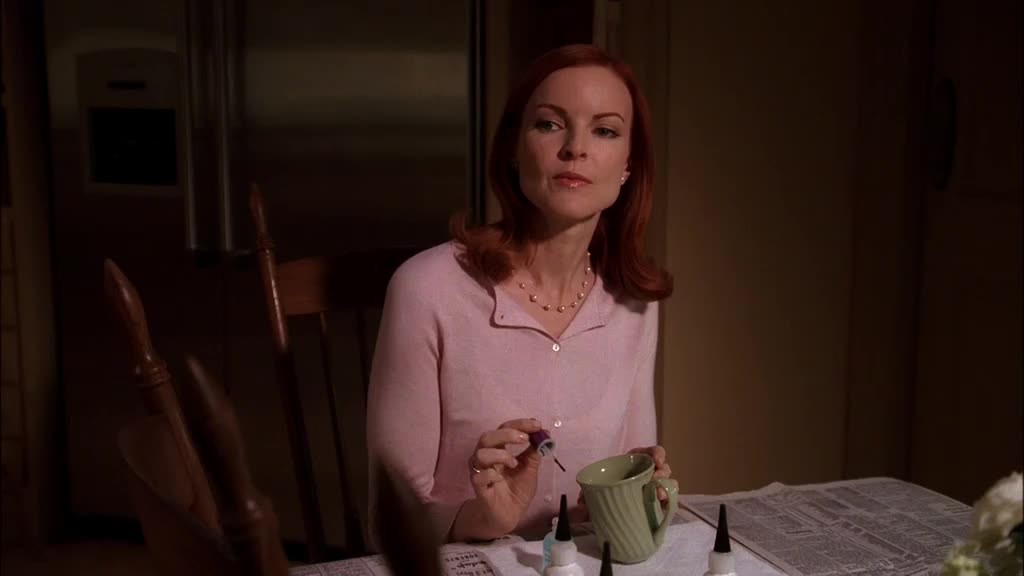 Bree is sitting at the kitchen table, quietly repairing a mug, when Rex walks in.jpg