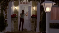 S01E01 SUSAN holds a measuring cup and walks up to EDIE's front porch