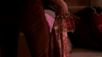 S01E01 SUSAN walks along the corridor, where she picks up a piece of EDIE's discarded clothing