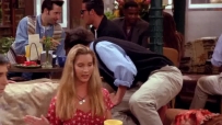 S01E03 Chandler leans over the back of the couch out of sight.