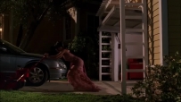 S01E01 She parks the car in her driveway, hurries into the open garage door, reappearing pushing the lawn mower
